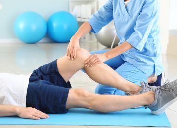 physiotherapist-working-with-male-patient-rehabilitation-center